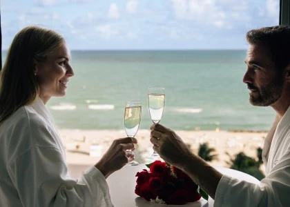 a man and woman holding champagne glasses
