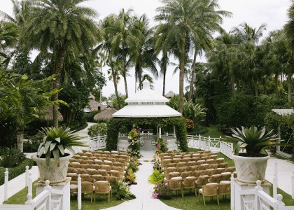 a wedding venue with chairs and trees