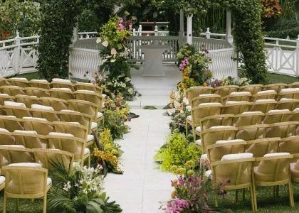 a wedding ceremony with chairs and flowers