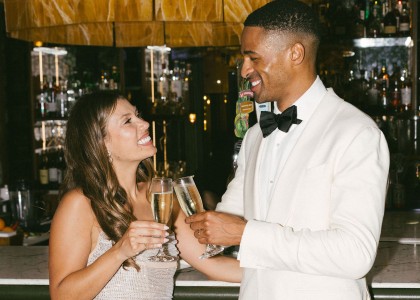 a man and woman holding champagne glasses