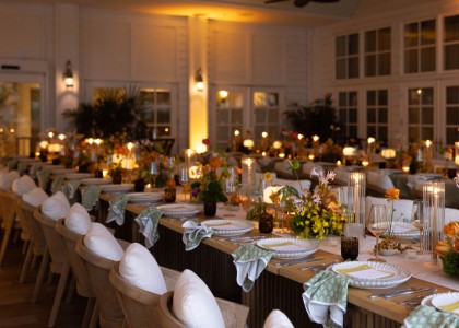a long table with plates and flowers