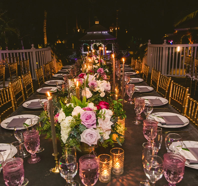 a long table with flowers and candles