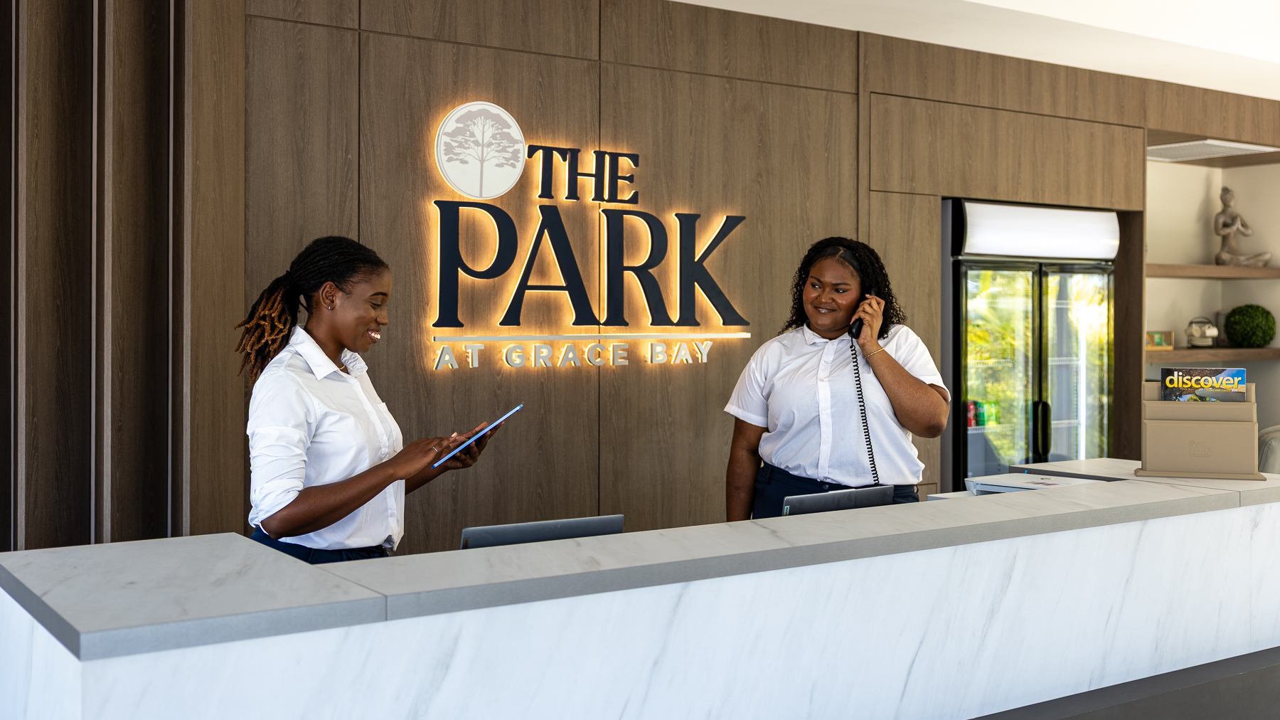 two women standing at a reception desk
