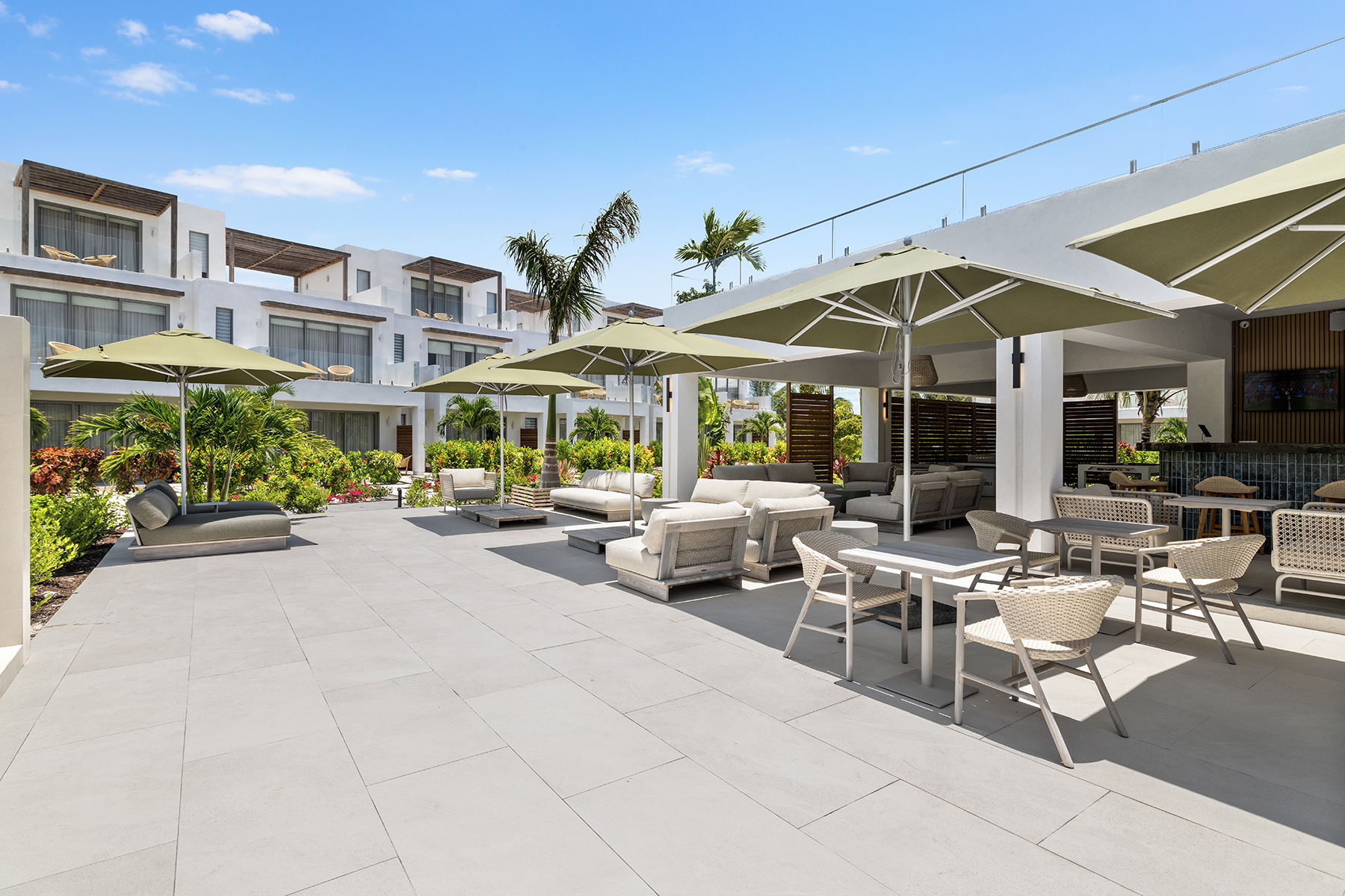 a patio with chairs and umbrellas