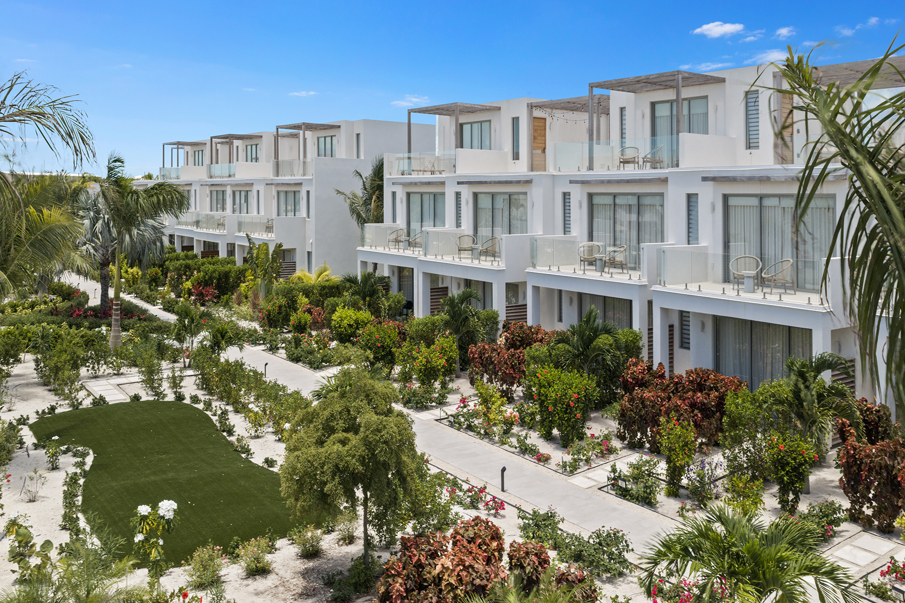 a white building with trees and bushes