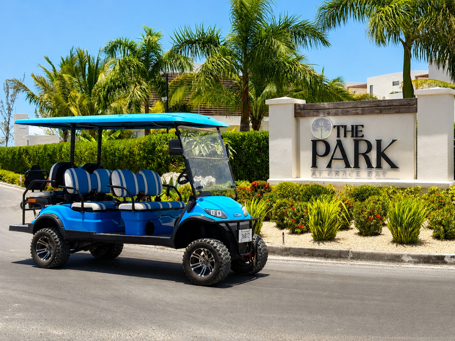 a blue golf cart parked in front of a sign
