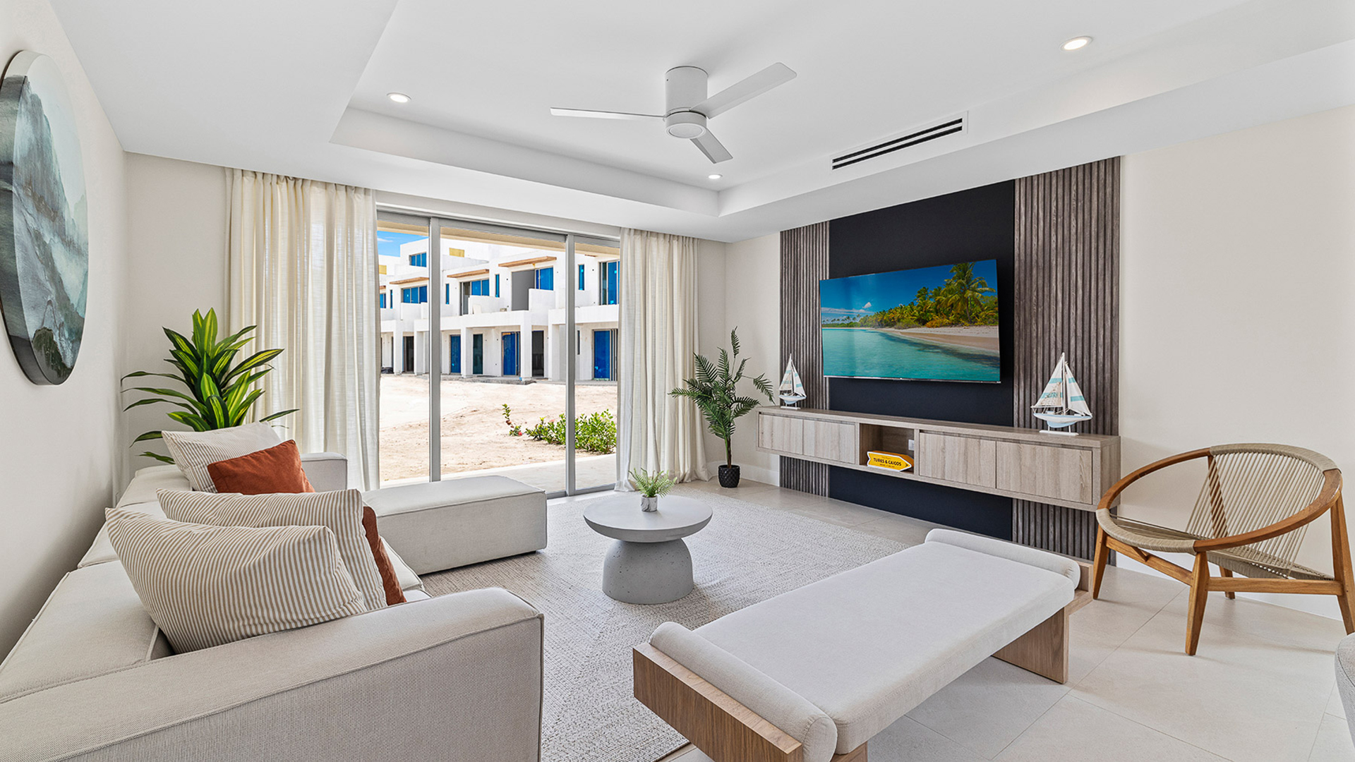 a living room with a television and a large window