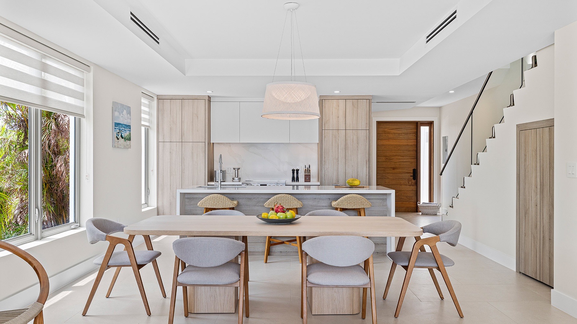 a dining table with chairs in a kitchen