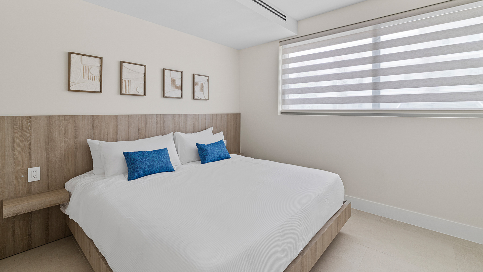 a bed with pillows and a window