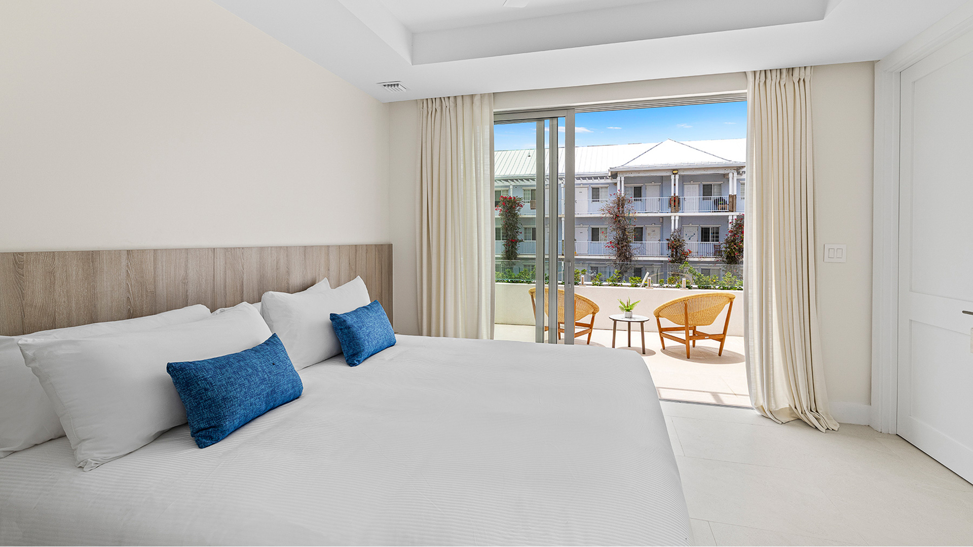 a bed with a glass door and a patio