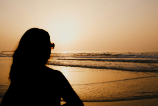 a silhouette of a woman on a beach
