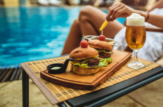 a woman sitting in a chair with a table with food on it