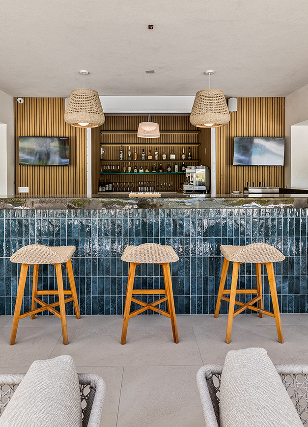 a bar with stools and lights