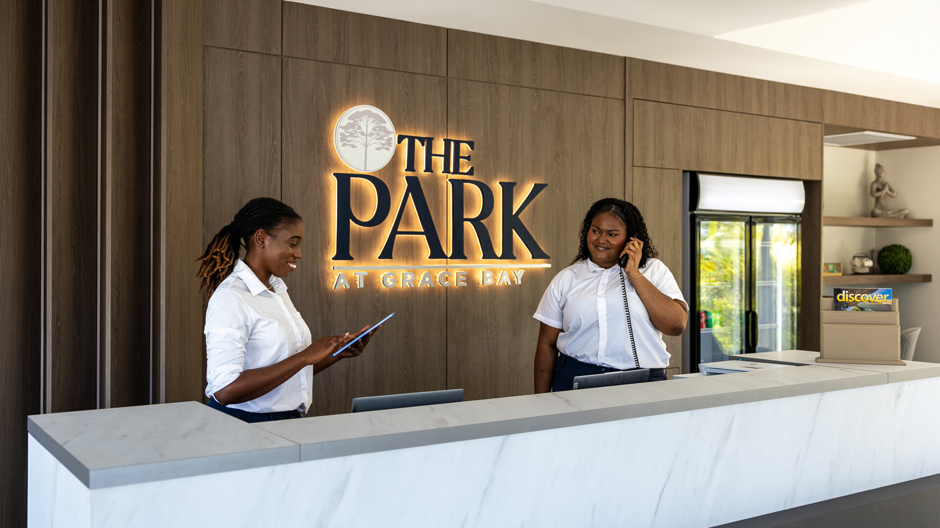 two women standing at a reception desk