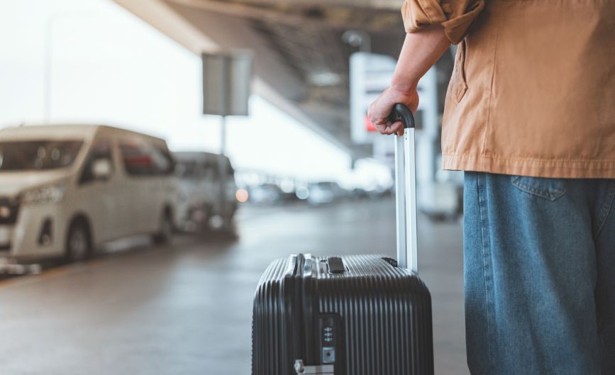 a person holding a luggage bag