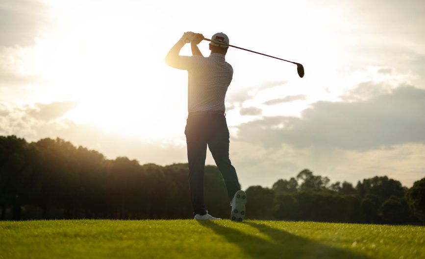 a man swinging a golf club