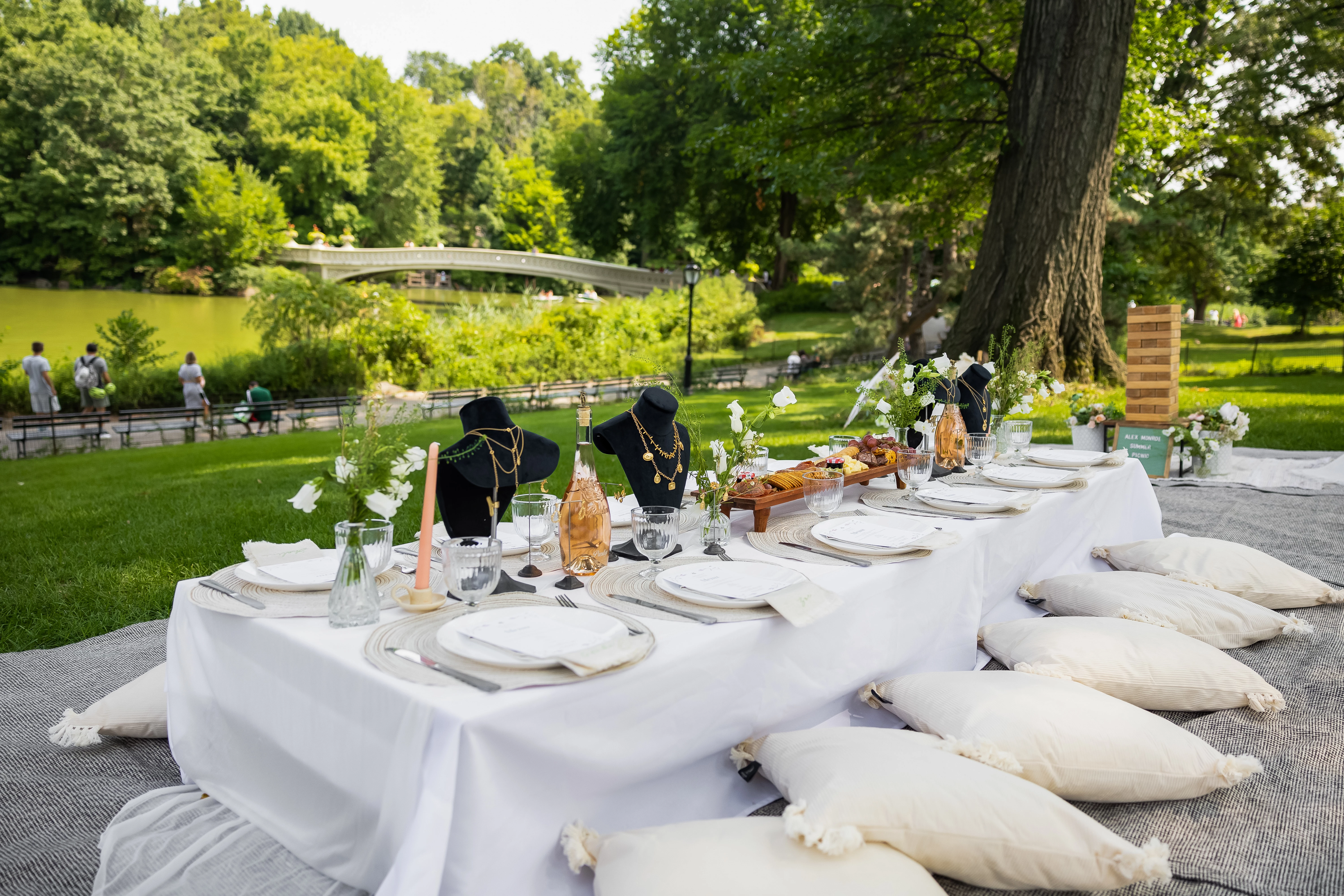 a table with white tablecloth and white pillows