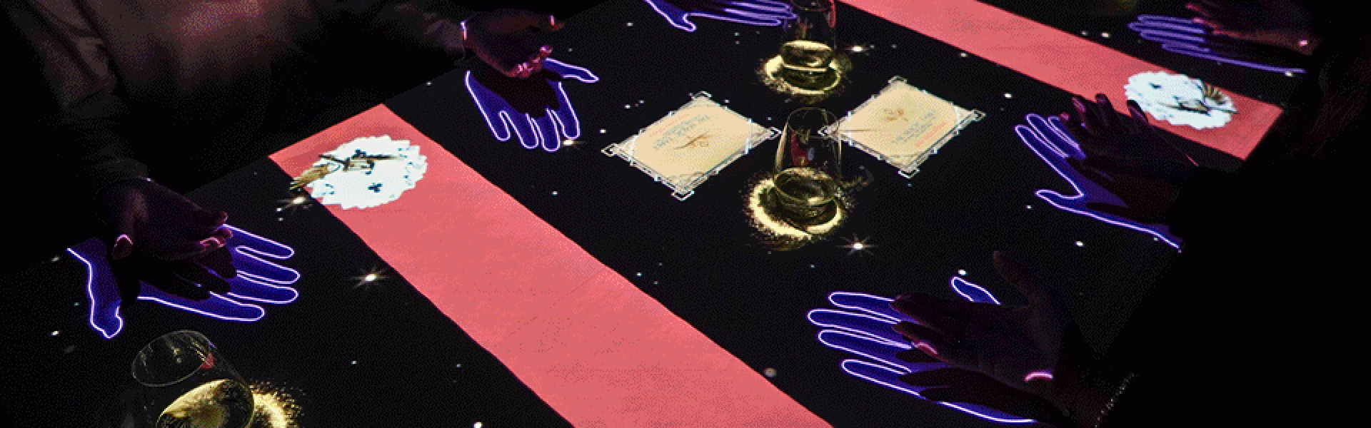 a group of people sitting at a table with a glowing table