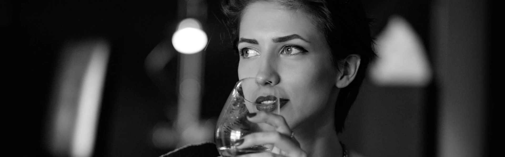 a woman holding a glass of wine