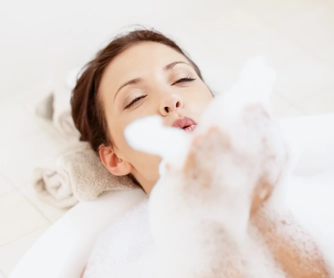 woman blowing bath bubbles