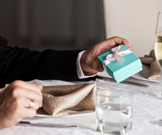 man holding small gift
