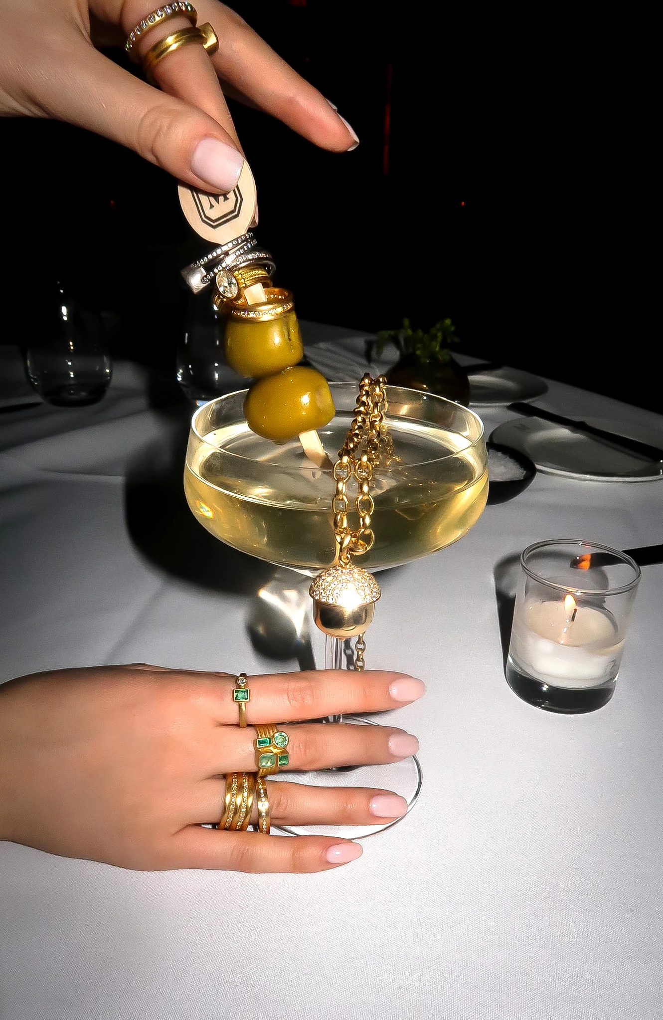 a hand pouring a drink into a glass