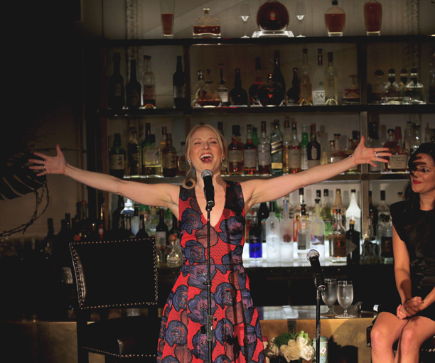 a person with the arms raised in front of a bar