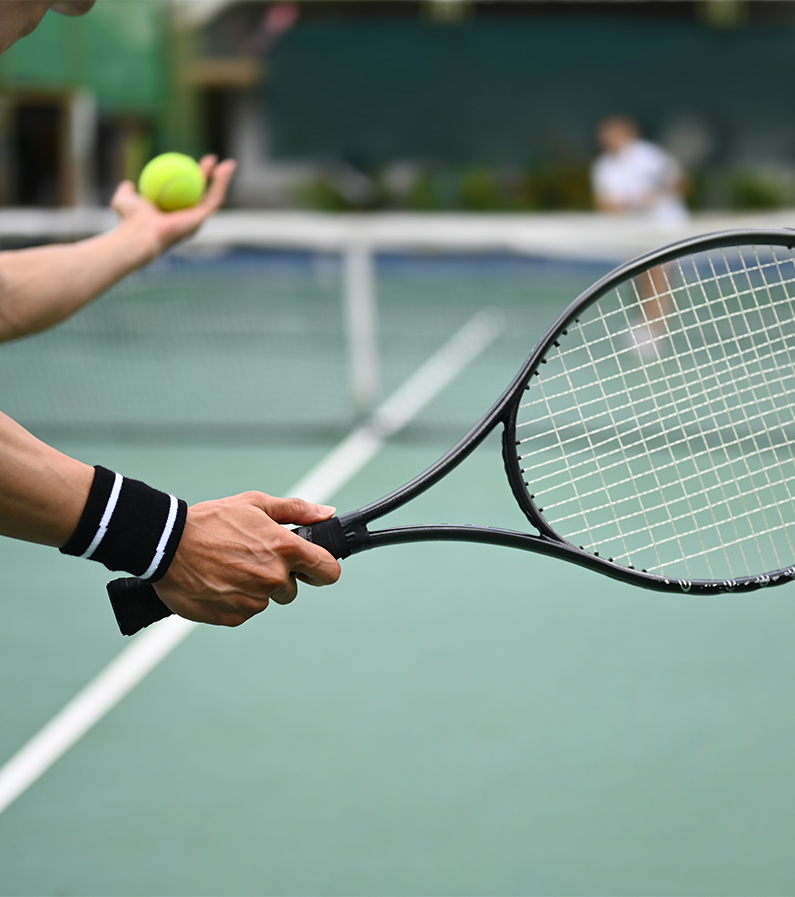 a person holding a tennis racket and a ball