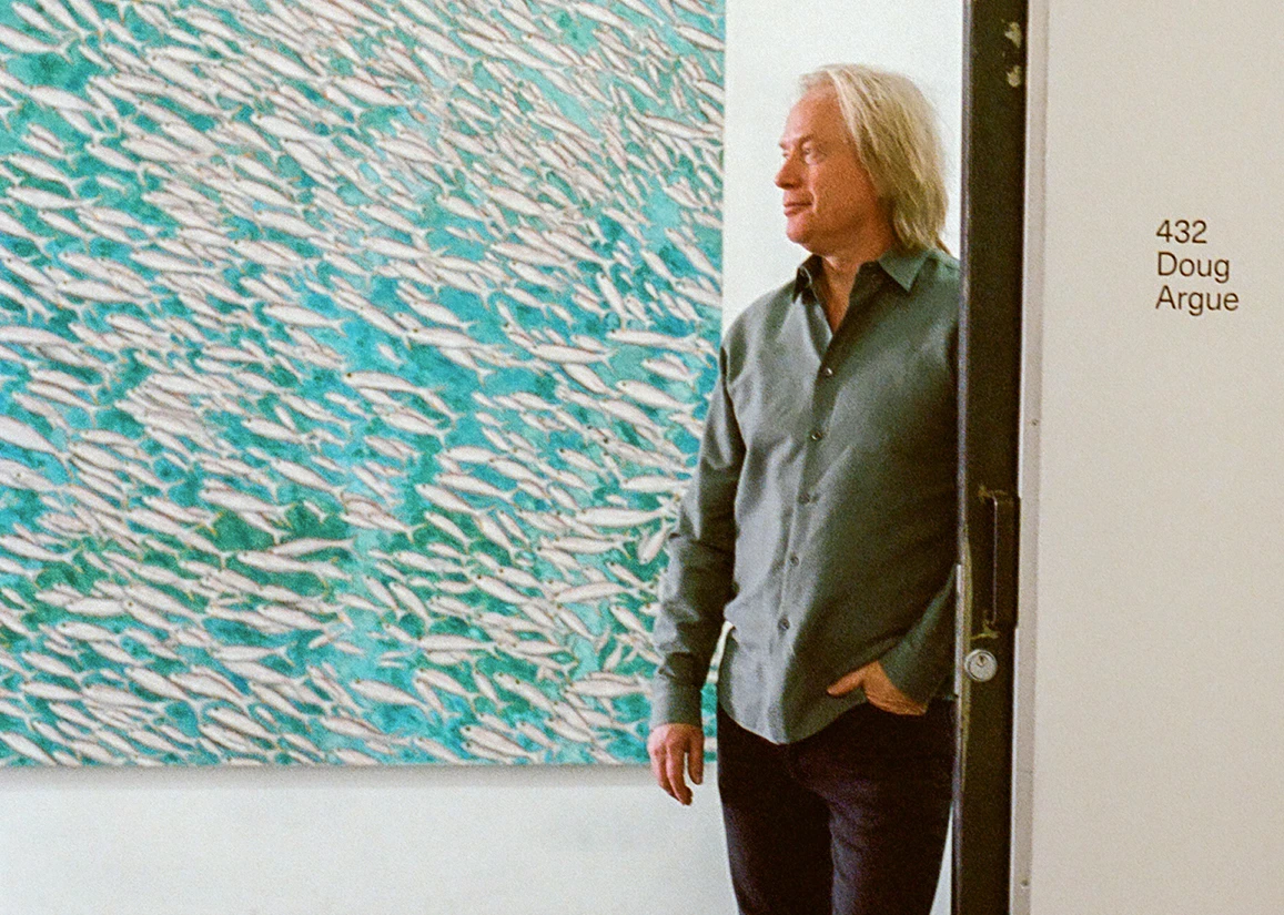 a man standing in front of a painting