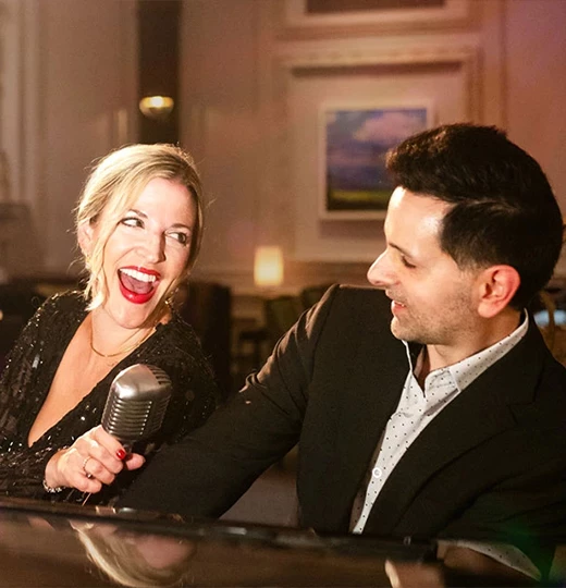 a man and woman singing into a microphone