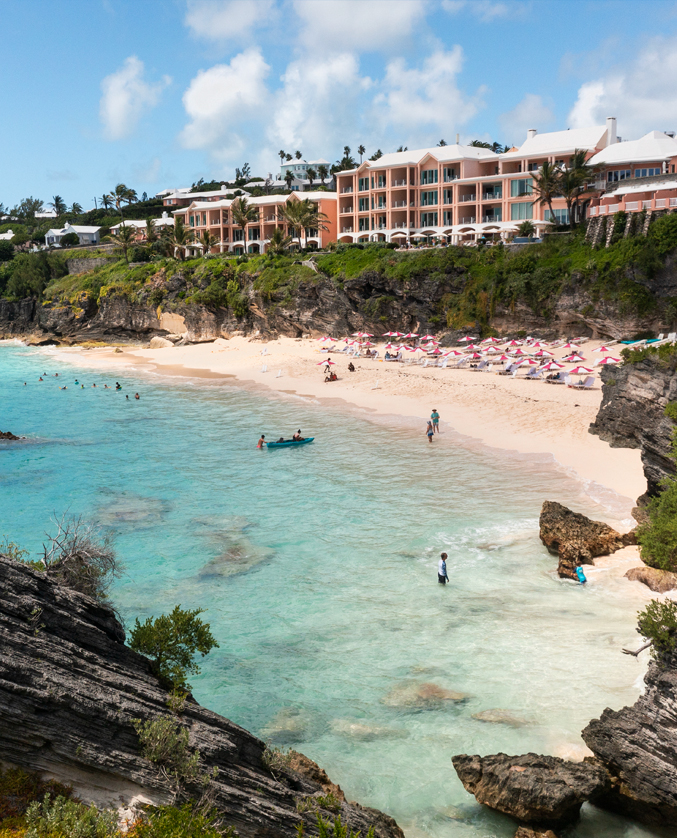 a beach with people and buildings with Bondi Beach in the background