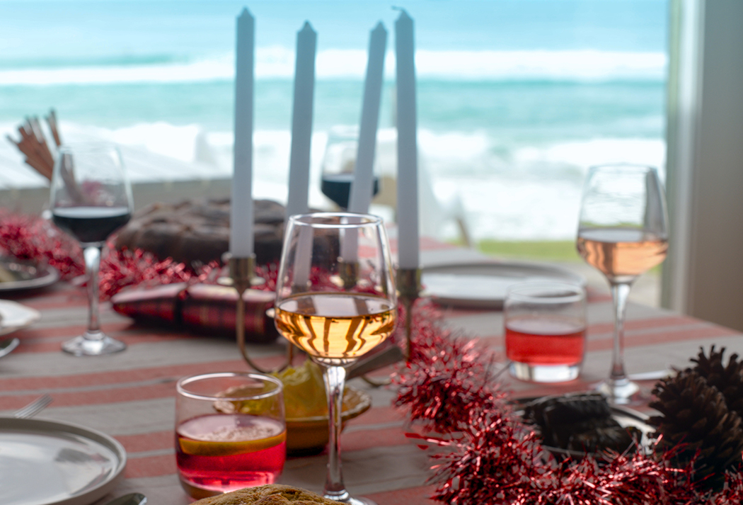 a table with wine glasses and tinsel on it