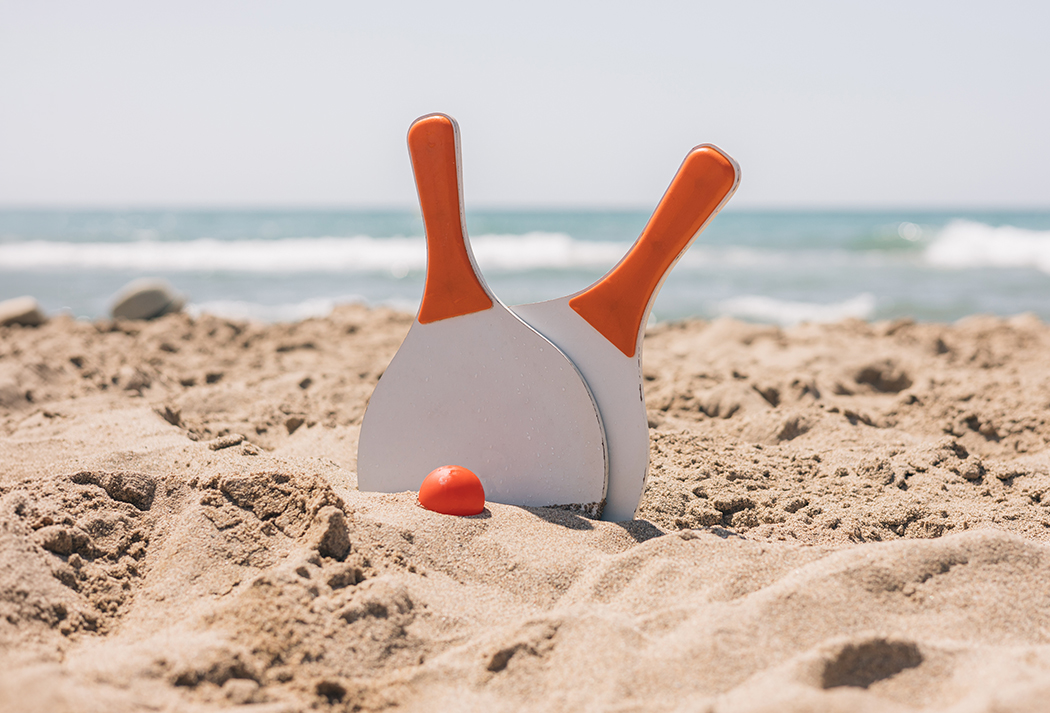 a paddles and a ball in the sand
