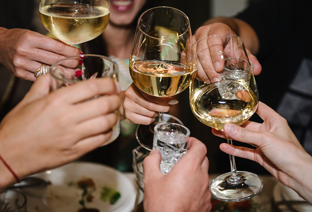 a group of people holding wine glasses