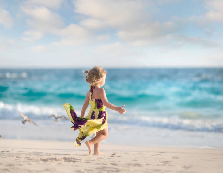 a girl running on a beach