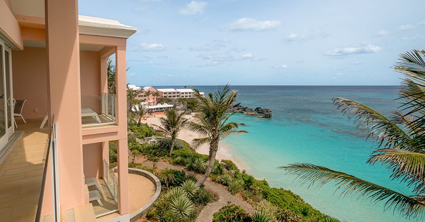 a building with palm trees and a beach