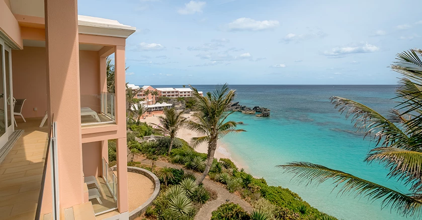 a building with palm trees and a beach