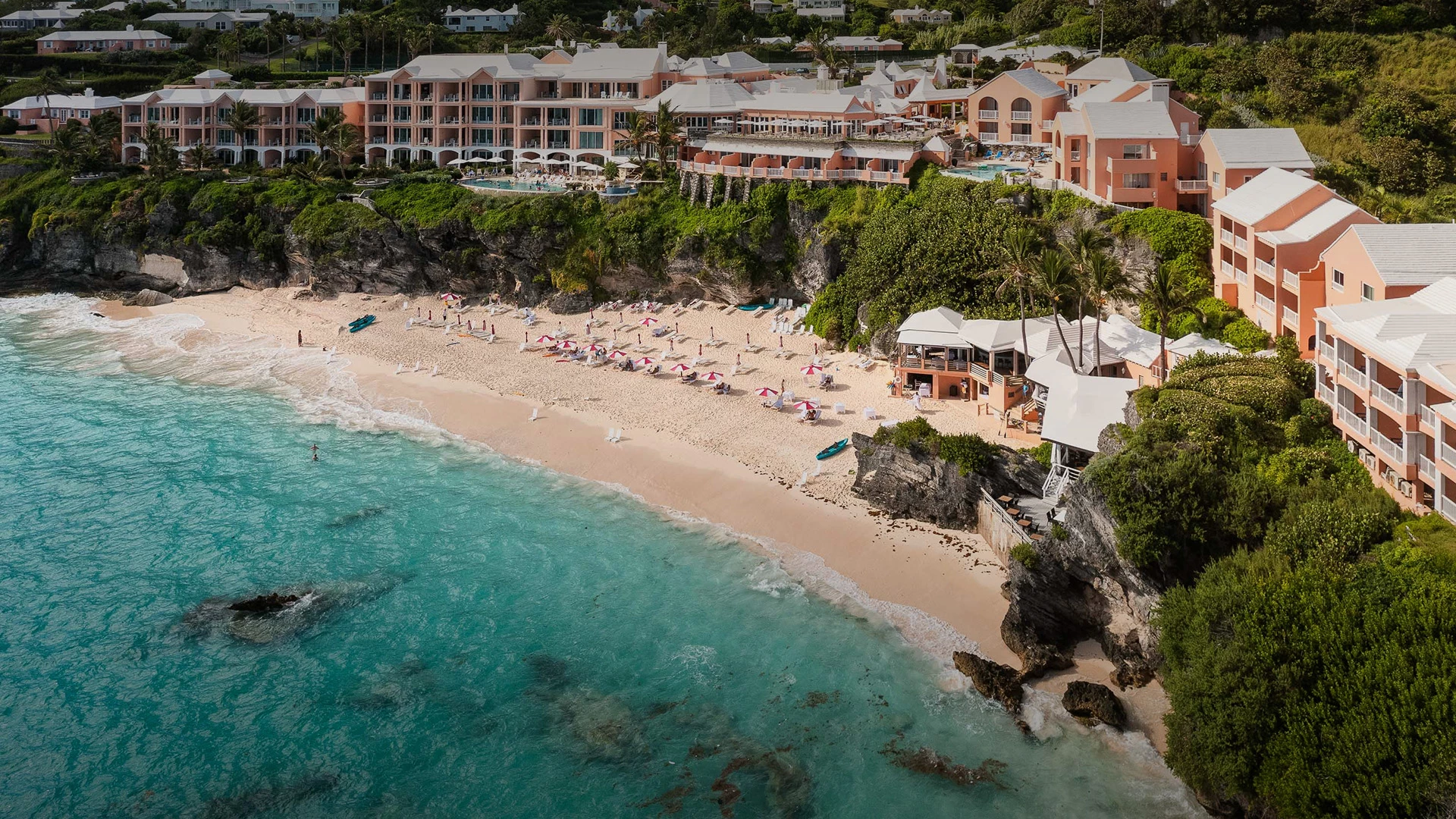 a beach with buildings and a body of water