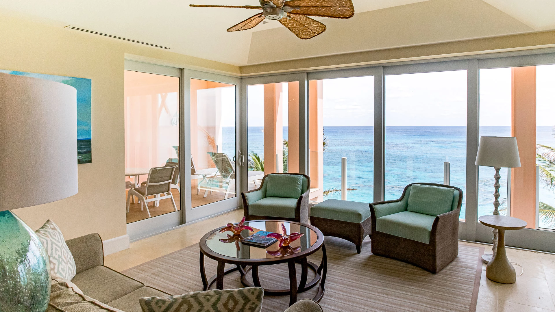 a living room with a fan and chairs
