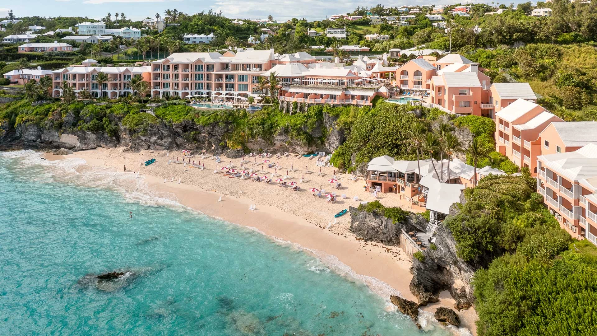a beach with buildings and a body of water