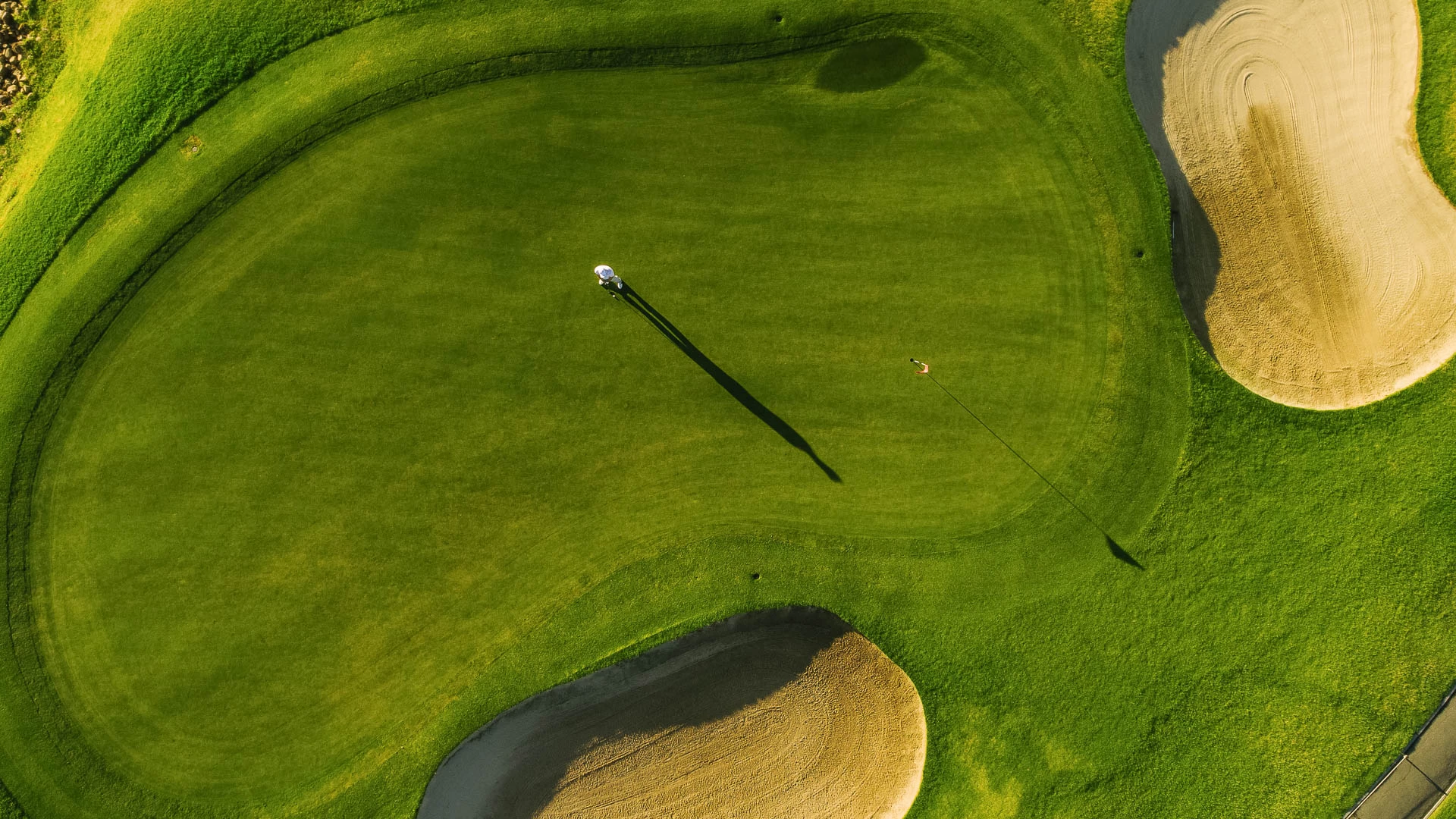a golf course with a flag on the ground