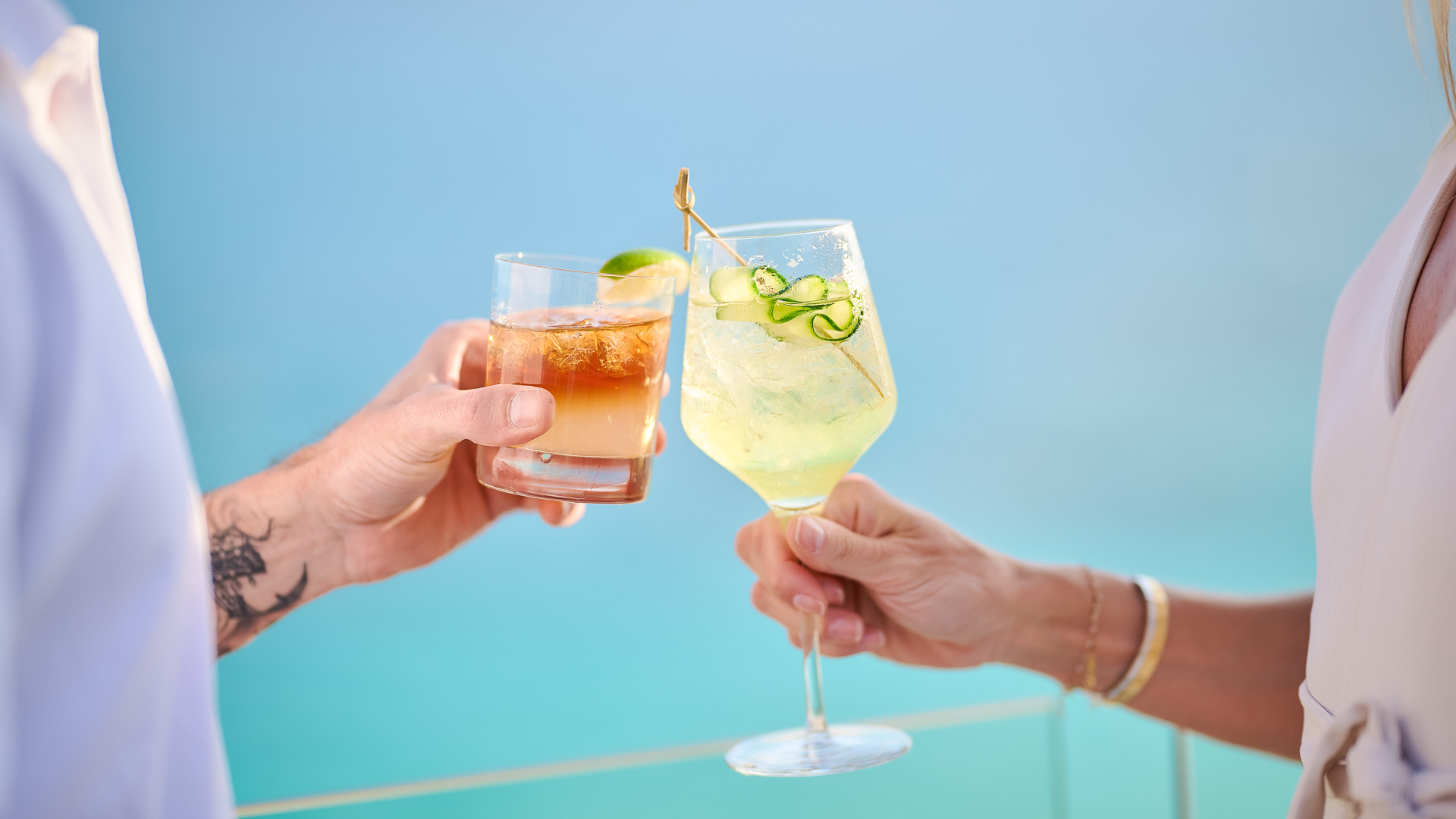 a pair of hands holding drinks