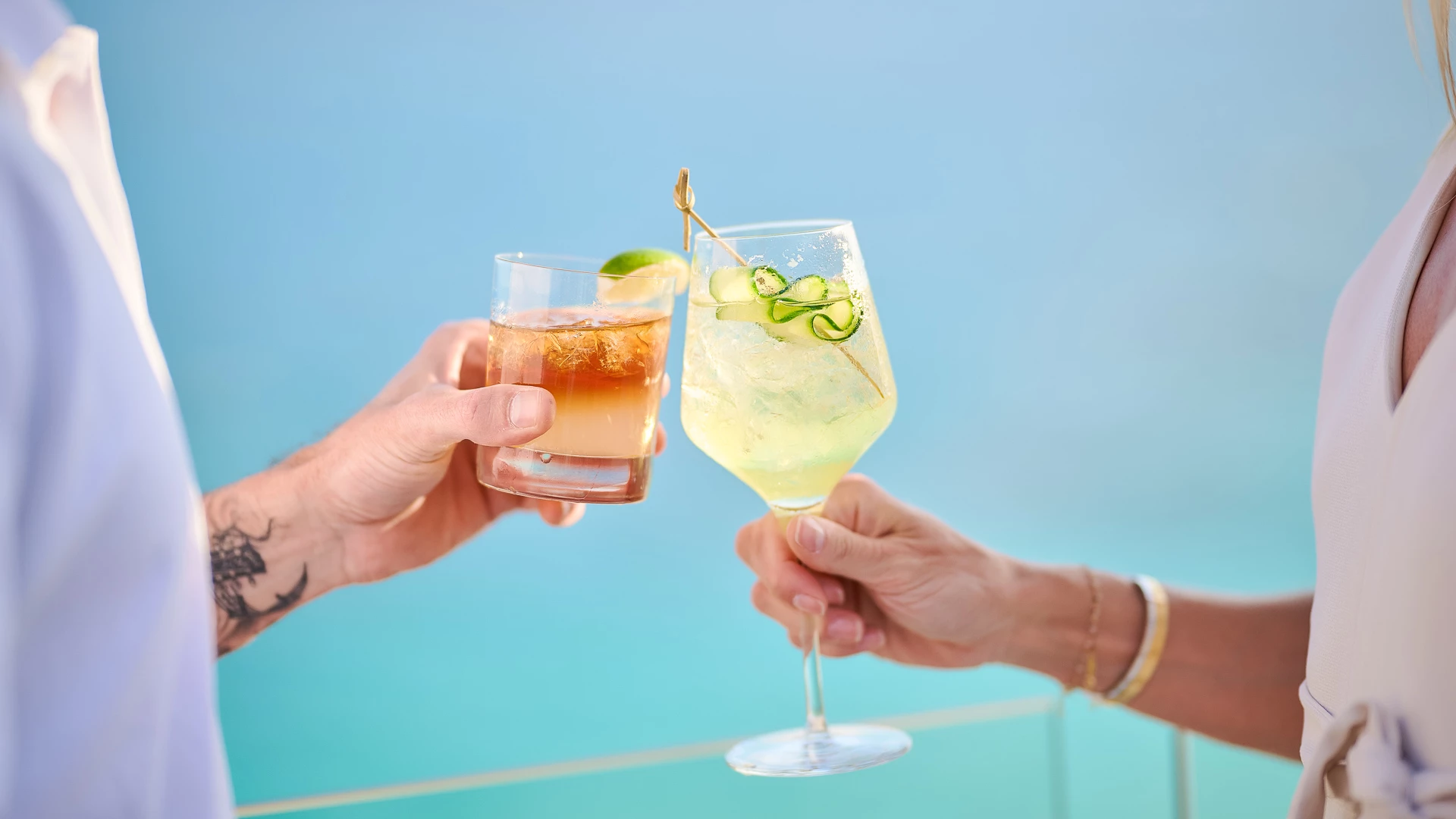 a pair of hands holding drinks