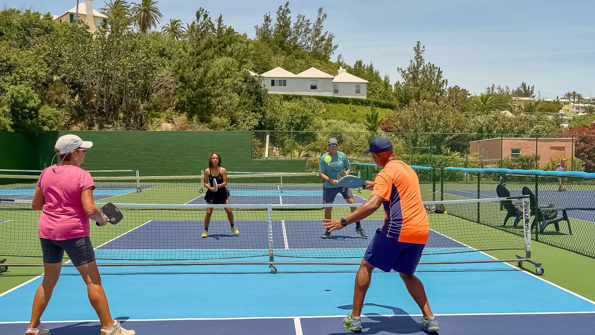 a group of people playing tennis