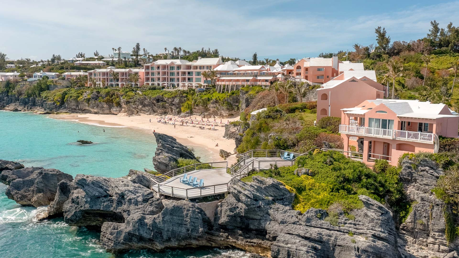 a beach with buildings and a body of water