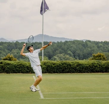 a man playing tennis on a court