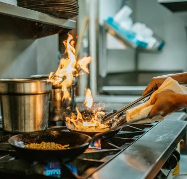 a person cooking food on a stove