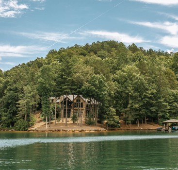 a house on a hill surrounded by trees