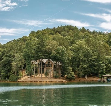 a house on a hill surrounded by trees