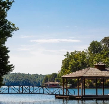 a gazebo on a dock over a lake